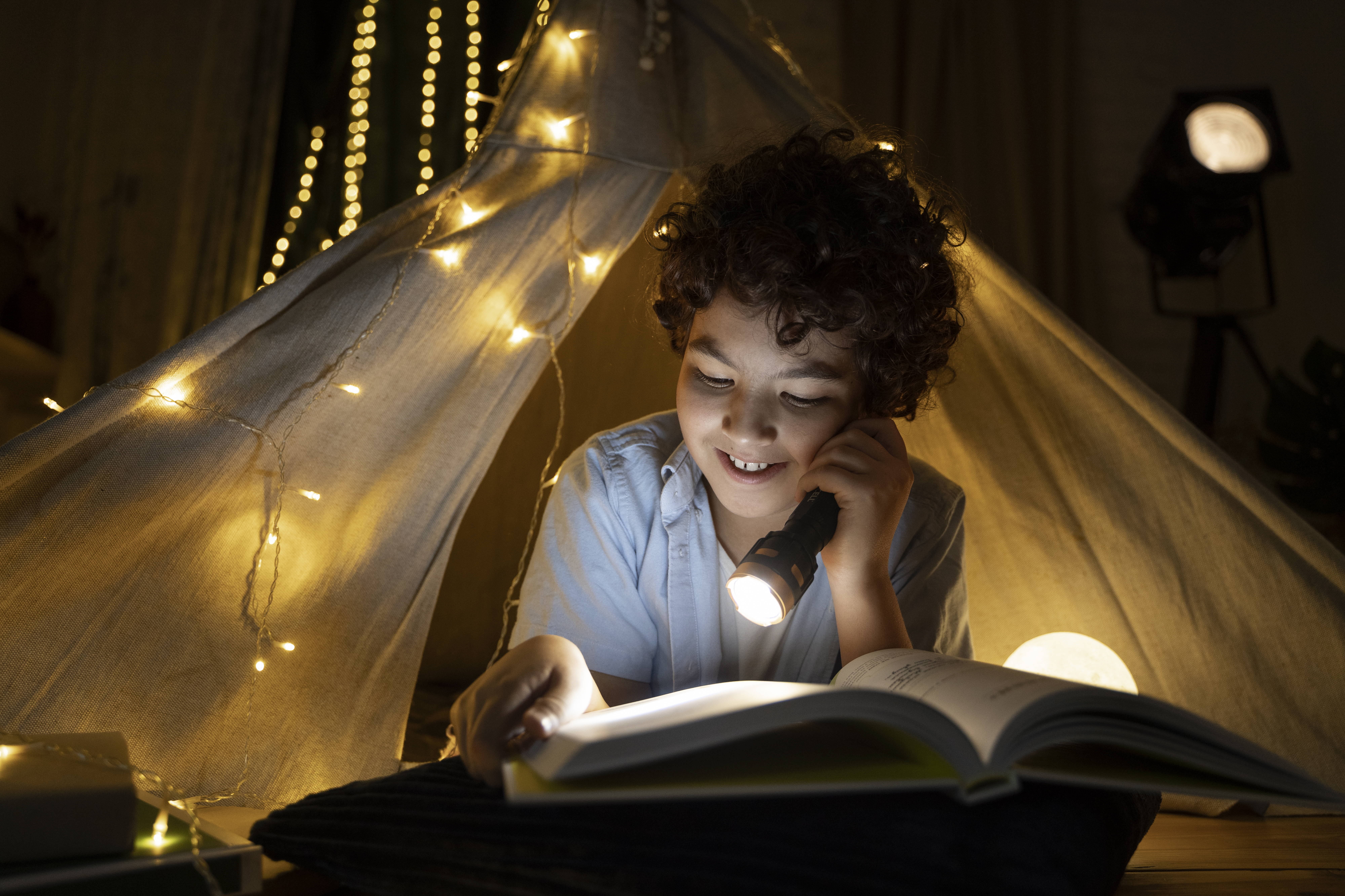 close-up-child-reading-his-house-tent